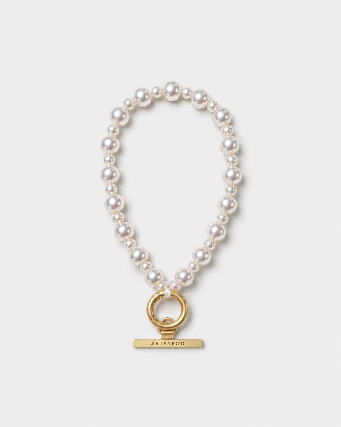 Ivory pearl beaded phone wristlet with gold clasp and ARTSYPOD branding on white background