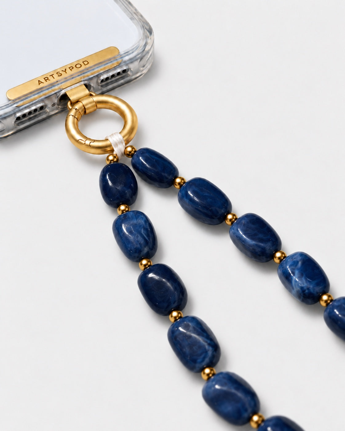 ARTSYPOD Navy Blue Marble wristlet close-up attached to phone case