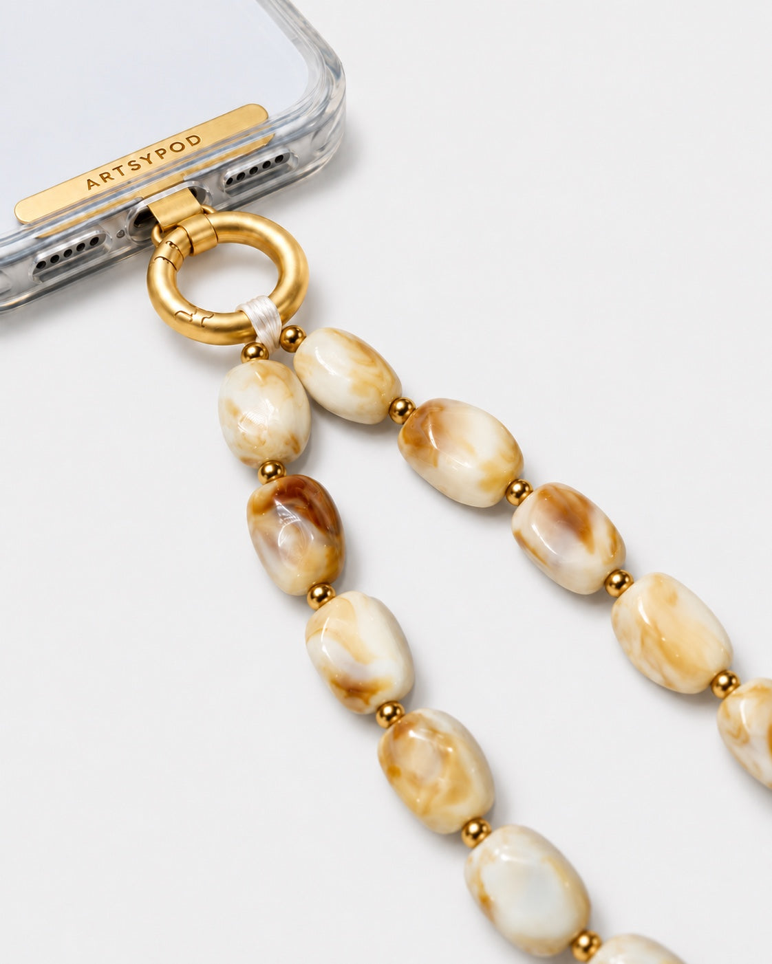 ARTSYPOD Honey Cream Marble wristlet close-up attached to phone case